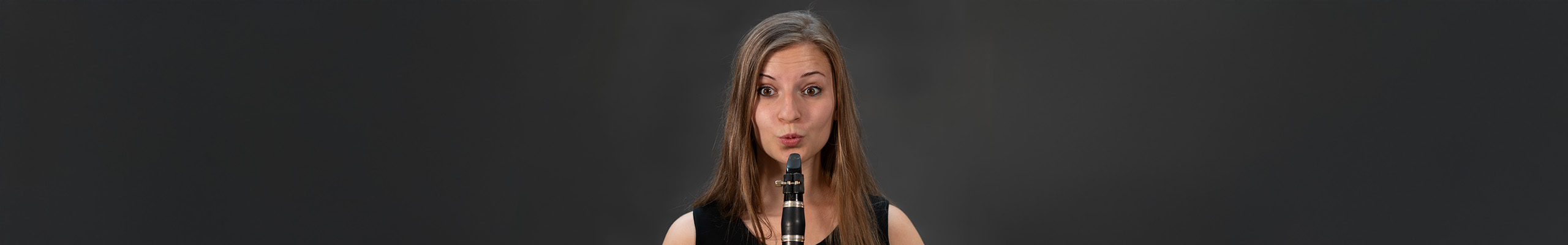 A clarinetist makes a surprised face.